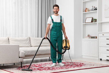 Canvas Print - Dry cleaner's employee hoovering carpet with vacuum cleaner in room