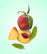 © New Africa - Juicy fresh peaches with green leaves falling on light turquoise background