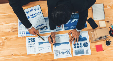Poster - Top view analyst team discussing financial data on digital dashboard, analyzing chart and graph papers by data science software on wooden table background. Business intelligence and Fintech. Fervent