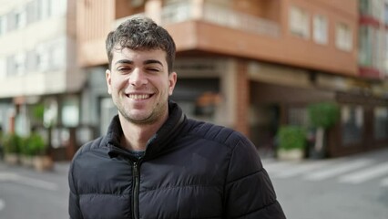 Canvas Print - Young hispanic man smiling confident at street