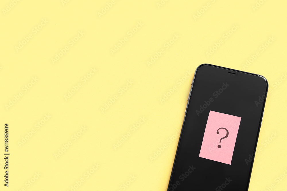 Mobile phone with question mark on yellow background