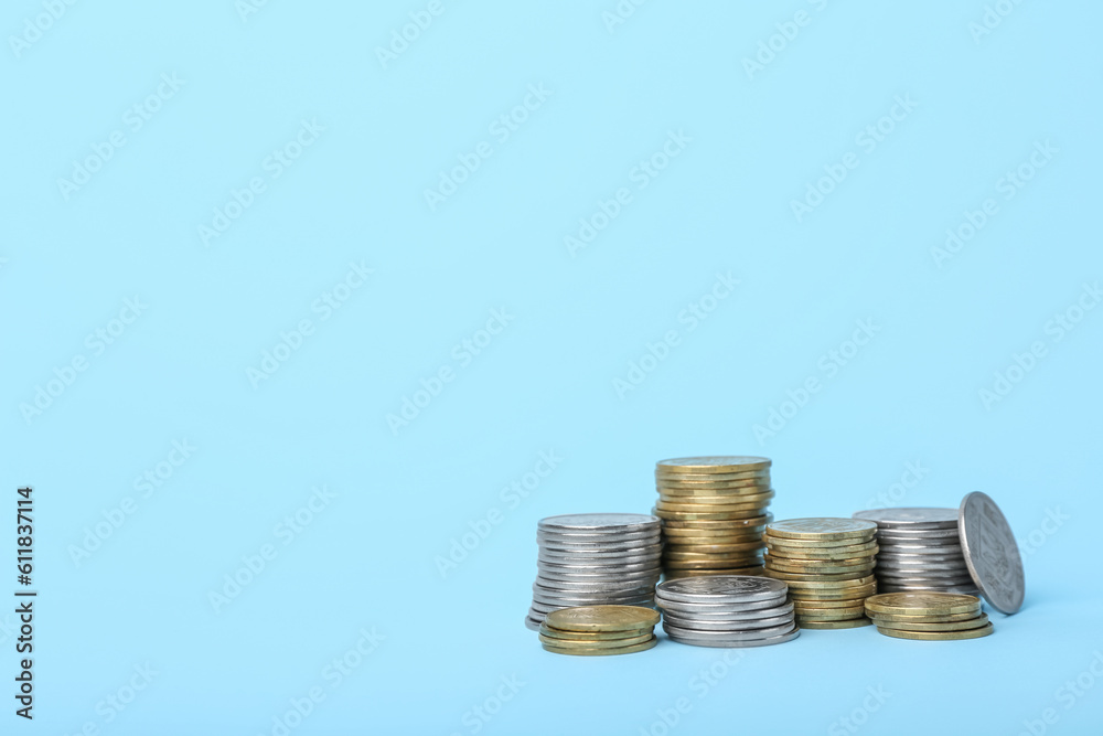 Stacks of coins on blue background