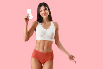 Wall Mural - Young woman in menstrual panties with pad on pink background