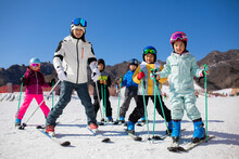 Children Learning How To Ski With Their Coach