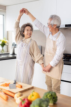 Cheerful Senior Couple Dancing In Kitchen