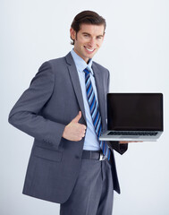 Wall Mural - Corporate man, laptop screen and thumbs up in portrait, like opinion and mockup space by white background. Businessman, funny entrepreneur and computer with good news, vote and promo for brand review