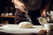 Midsection Of Chef Kneading Dough