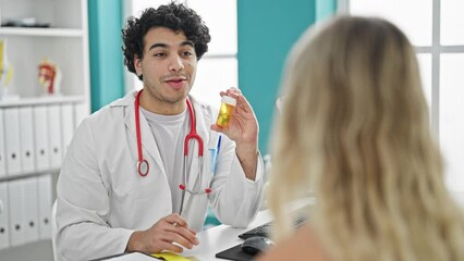 Wall Mural - Young latin man doctor with patient prescribe pills treatment at clinic