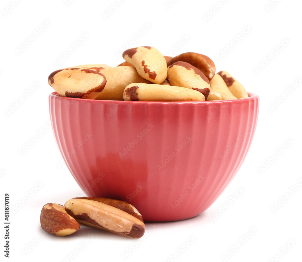 Bowl of tasty Brazil nuts on white background
