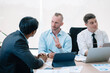 © NINENII - Group of diverse business people discussing a project in a meeting for analysis graph company financial.