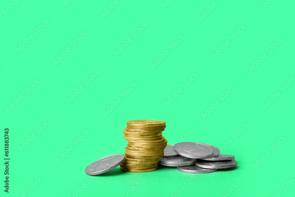 Stack of coins on green background