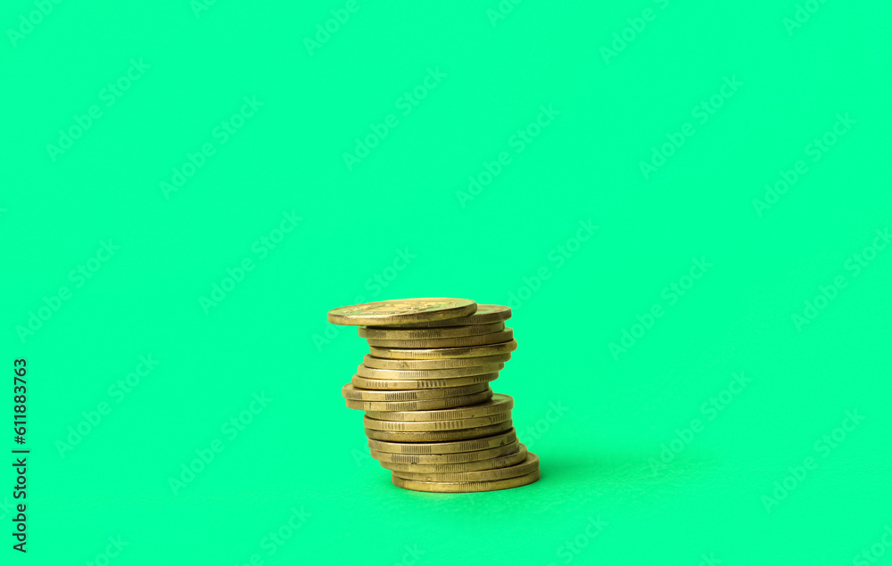Stack of coins on green background