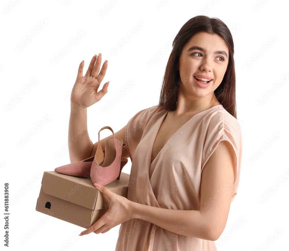 Young woman with shoe box waving hand on white background