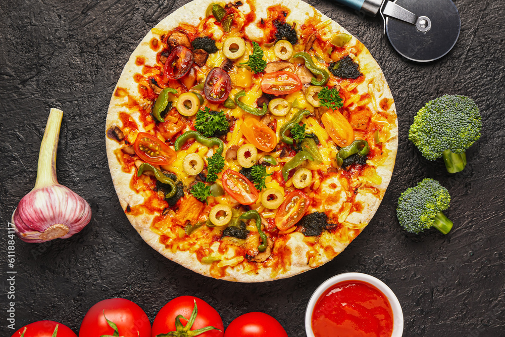 Vegetable pizza with ingredients and cutter on dark background