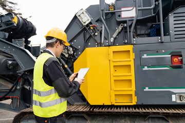 Aufkleber - Engineer with digital tablet next to road construction machine.