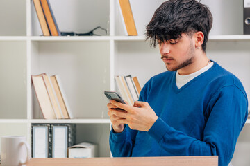 Canvas Print - young male student with mobile phone or smartphone