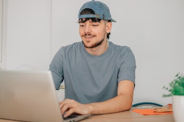 Wall Mural - young man at desk with computer