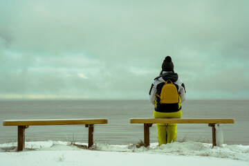 two romantic benches on the shore of the snowy sea and women