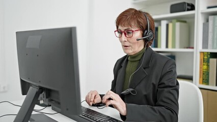 Sticker - Mature hispanic woman university teacher putting headset on at library university