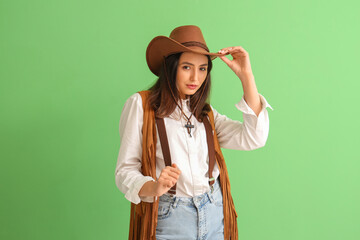 Poster - Beautiful cowgirl on green background