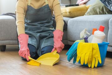 Wall Mural - Household hygiene clean up, housekeeper woman hand in pink rubber protective gloves with yellow broom and dustpan sweeping remove dust on floor at home, equipment or tool for cleaning, cleaner people.