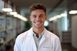 © igolaizola - Portrait of a young male doctor smiling at camera in hospital corridor