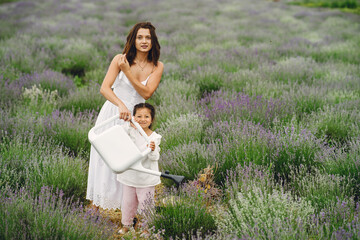 Little girl with her mother in a lavender field