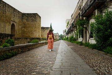 Wall Mural - Girl walking in the streets of Cordoba, Andalucia, Spain