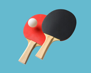 Wall Mural - Pair of table tennis paddle and ball isolated on a blue background