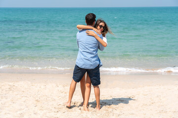 Wall Mural - Vacation romantic love young happy smile couple in honeymoon travel holiday trip standing on sand at blue sky sea beach having fun and relaxing together on tropical beach.Summer travel