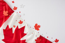 Celebrating Canada's Day Theme. Top View Flat Lay Of National Flag, Red Maple Leaves, Stars On White Background With Empty Space For Text Or Promo