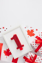 Wall Mural - Idea for Fun-Filled 1st of July Canada Day Party. Top view vertical photo of national flag, patriotic gift boxes, red white stars and frame with numeral 1 candle on white background with space for ad