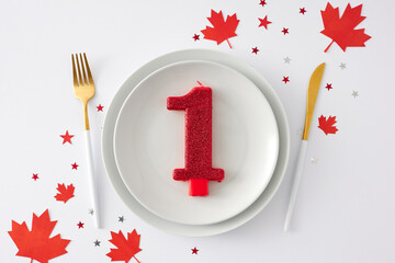 Wall Mural - Patriotic table design celebrating Victoria Day. Top view flat lay of plate with numeral 1 candle, cutlery knife fork, red maple leaves, star-shaped confetti on white background