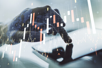 Poster - Multi exposure of abstract financial graph with world map and hand working with a digital tablet on background, financial and trading concept