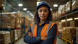 © wetzkaz - woman in production hall and warehouse, safety helmet and work jacket, crossed arms, interior, storage space, warehouse and logistics, pallets with products ready for collection, fictitious place