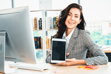 Empty tablet computer screen shown by woman in office for product , website and mobile app presentation. Jivy