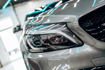 interior of modern car workshop for vehicle polishing and detailing service. brightly lit workspace 