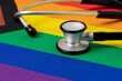 © JJ Gouin - Rainbow pride flag and stethoscope. Transgender and LGBTQ+ healthcare and mental health concept.