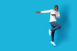 © Prostock-studio - Amazed young black guy jumping up, pointing at copy space