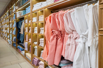 Leinwandbilder - Soft colors cotton textile bathtowels, terry towels, bathrobes, fluffy pillows and warm bedblankets in a shop shelves. Shelving in the store with neatly folded towels on the shelves and accessories