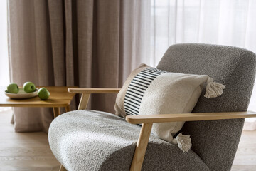 Wall Mural - Apartment with chic grey armchair and cushion near wooden table