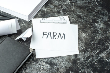 Wall Mural - front view of white sheet with farm writing and notebook ruler pens blanks paper plane on gray distr