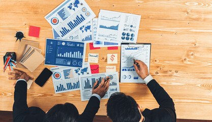 Poster - Top view analyst team discussing financial data on digital dashboard, analyzing chart and graph papers by data science software on wooden table background. Business intelligence and Fintech. Fervent