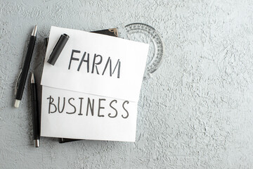 Wall Mural - top view of business and farm writings on white sheets ruler pens on the right side on gray sand bac