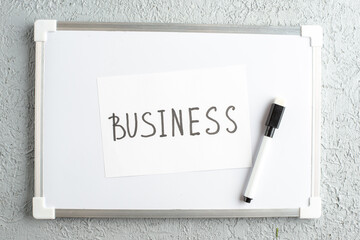Wall Mural - top view of business writing and marker on white desk on gray sand background