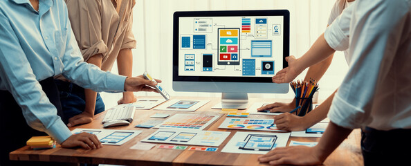 Aufkleber - Panorama shot of front-end developer team brainstorming UI and UX designs for mobile app on laptop computer screen. User interface development team planning for user-friendly UI design. Scrutinize