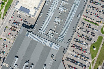 Wall Mural - aerial top view of crowded parking lot near big shopping mall. drone photo looking down.