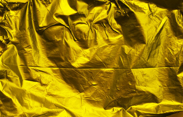 Poster - Golden crumpled plastic texture background