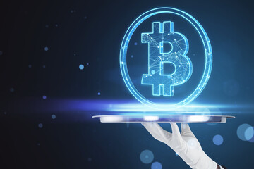 Poster - Close up of businessman hand holding tray with glowing blue bitcoin hologram on blurry bokeh circles background. Cryptocurrency and finance concept.