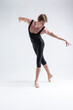 © danmorgan12 - Sports Concepts. Athletic Caucasian Dancing Ballet Man Posing in Stretching Pose Hips bended With Hands Backwards in Black Tights On White.